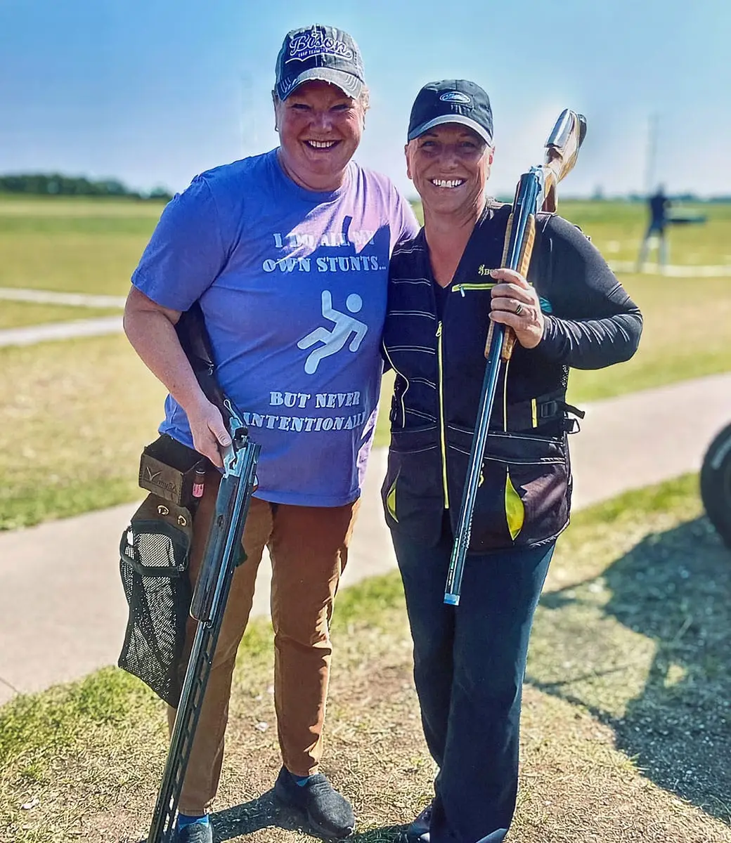 Female trap shooters pose for a photo after shooting clays
