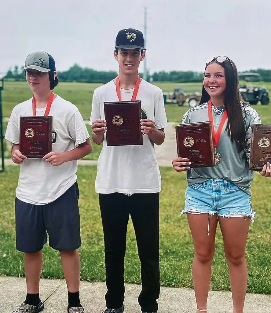 Youth trap shooting champions posing with awards